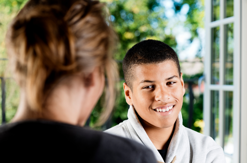 Male adolescent talking to a therapist.